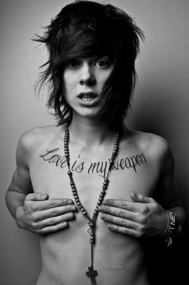 Christopher Drew's Tattoo on his chest love is my weapon