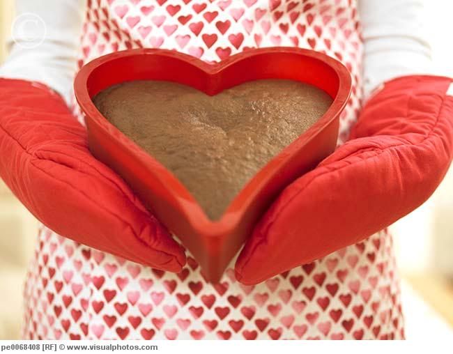 close_up_of_woman_holding_heart-shaped_cake_pe0068408.jpg